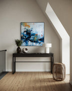 Modern interior with a console table, abstract painting, and decorative items.