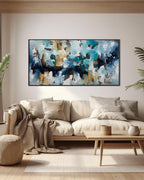 blue, white and yellow original abstract painting by artist Omar Obaid, large long horizontal art on wall above beige neutral sofa and home decor in living room